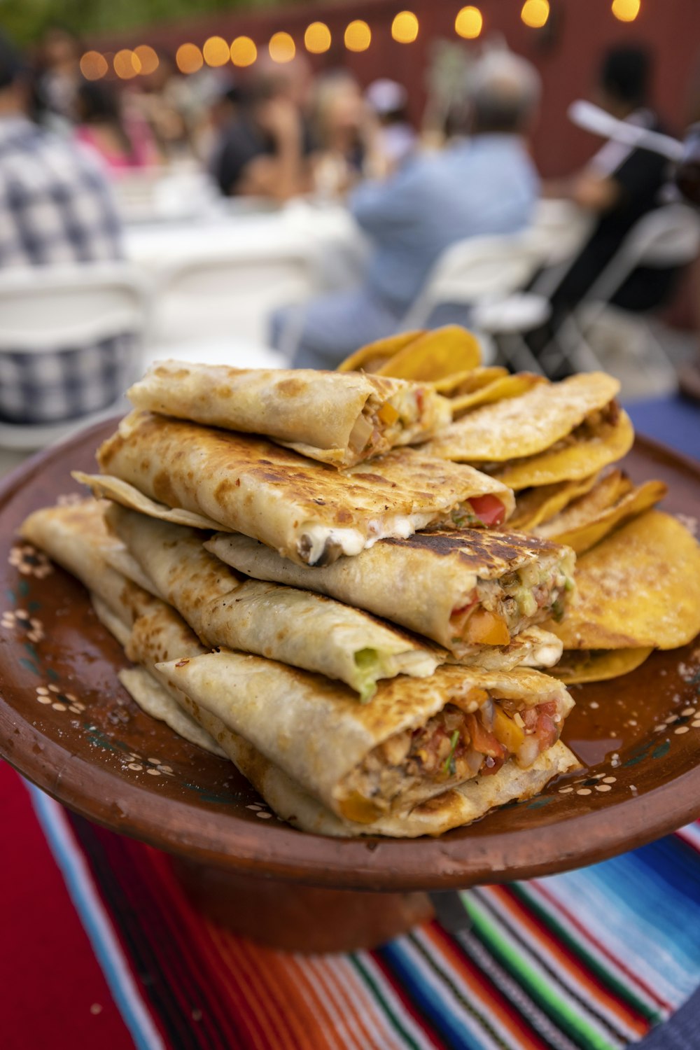 a plate full of quesadillas sitting on a table