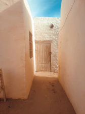 a narrow alley way with a wooden door
