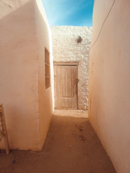 a narrow alley way with a wooden door