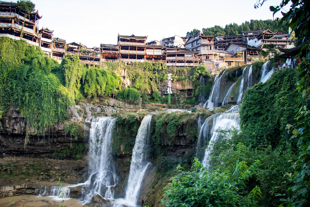 a waterfall in the middle of a lush green forest