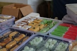 Packaging of assorted healthy snack packs from Taiwan and Thailand on a rustic table.