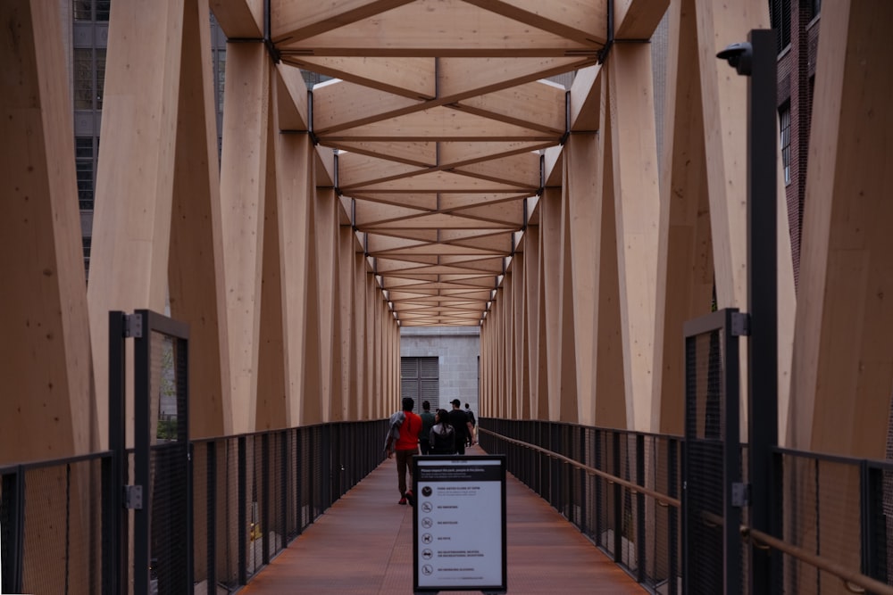 a walkway with a sign and people walking on it