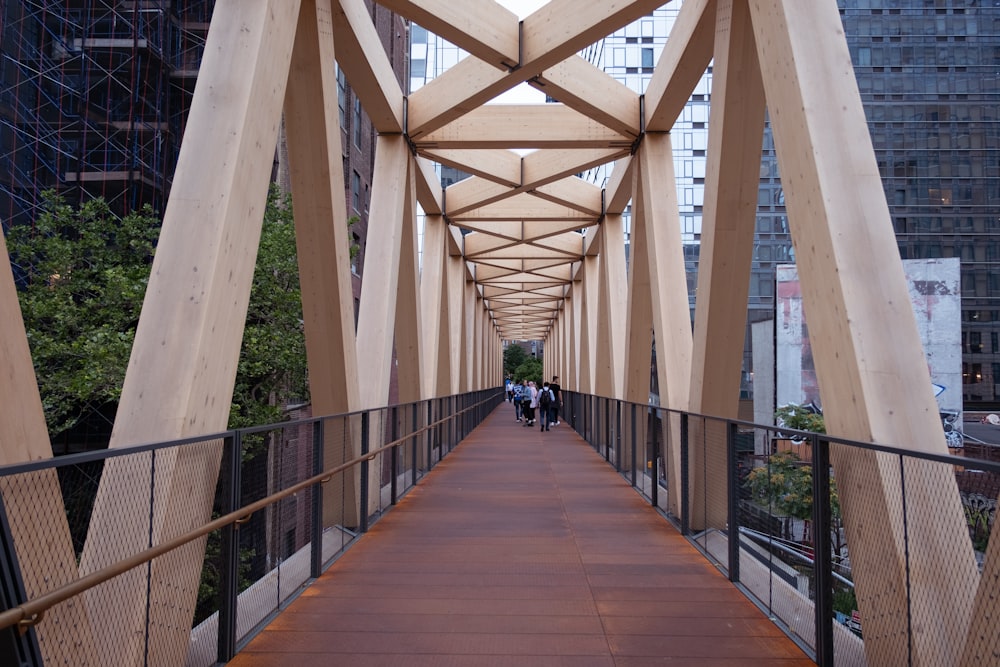 a wooden bridge with people walking across it