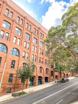 a large brick building sitting on the side of a road
