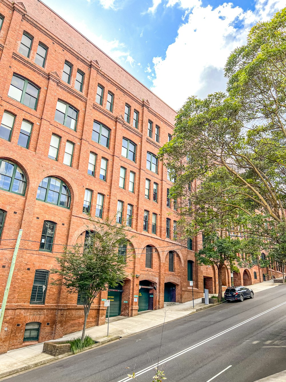 a large brick building sitting on the side of a road