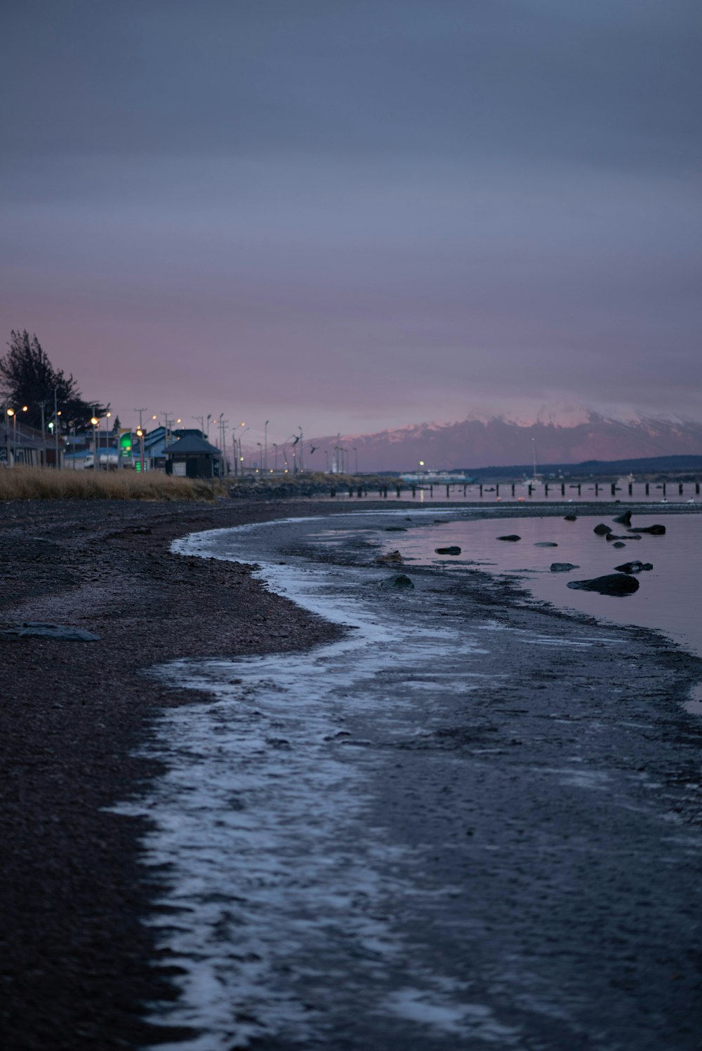 a body of water with a bridge in the background