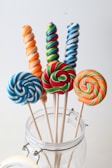 Delicious prtn lollipops arranged in a glass jar with a soft natural light.