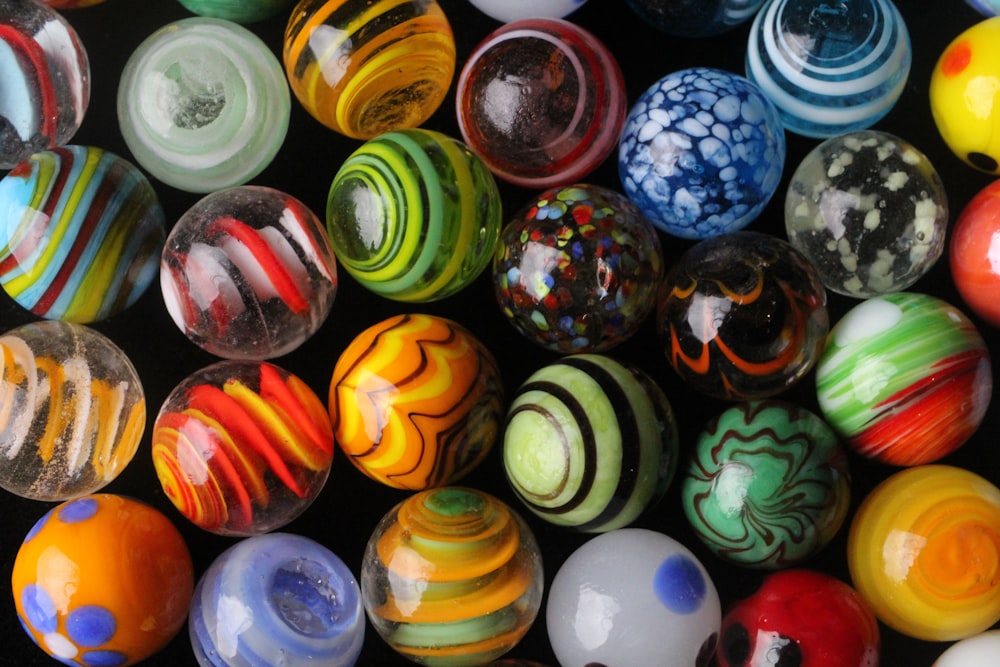 a bunch of different colored marbles sitting on top of each other