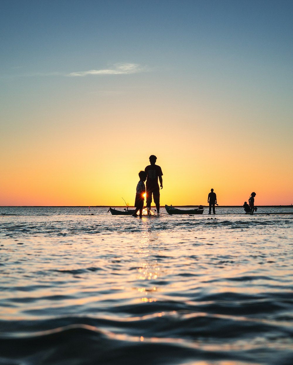 a group of people standing on top of a boat in the ocean