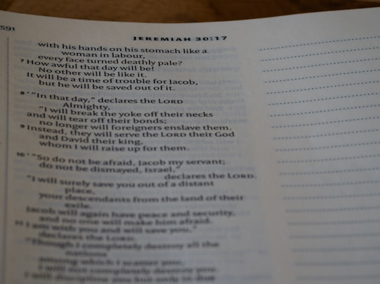 A close-up view of a Bible page open to Jeremiah 30:17, showing text in English with a focus on verses 7-9. The page is slightly tilted with a lined margin on the right.