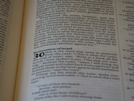 A close-up of an open book displaying text. The page contains a chapter titled 'Restoration of Israel' with a section numbered 30. The text is in English and formatted in paragraphs, with some words in bold to denote headings or sub-sections.
