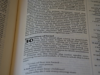 A close-up of an open book displaying text. The page contains a chapter titled 'Restoration of Israel' with a section numbered 30. The text is in English and formatted in paragraphs, with some words in bold to denote headings or sub-sections.