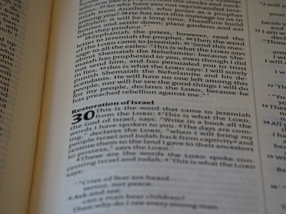 A close-up of an open book displaying text. The page contains a chapter titled 'Restoration of Israel' with a section numbered 30. The text is in English and formatted in paragraphs, with some words in bold to denote headings or sub-sections.
