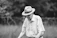 an old man wearing a hat and holding a tennis racquet