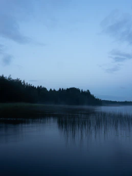 A calm, serene lakeside at dawn symbolizing peace and stability.