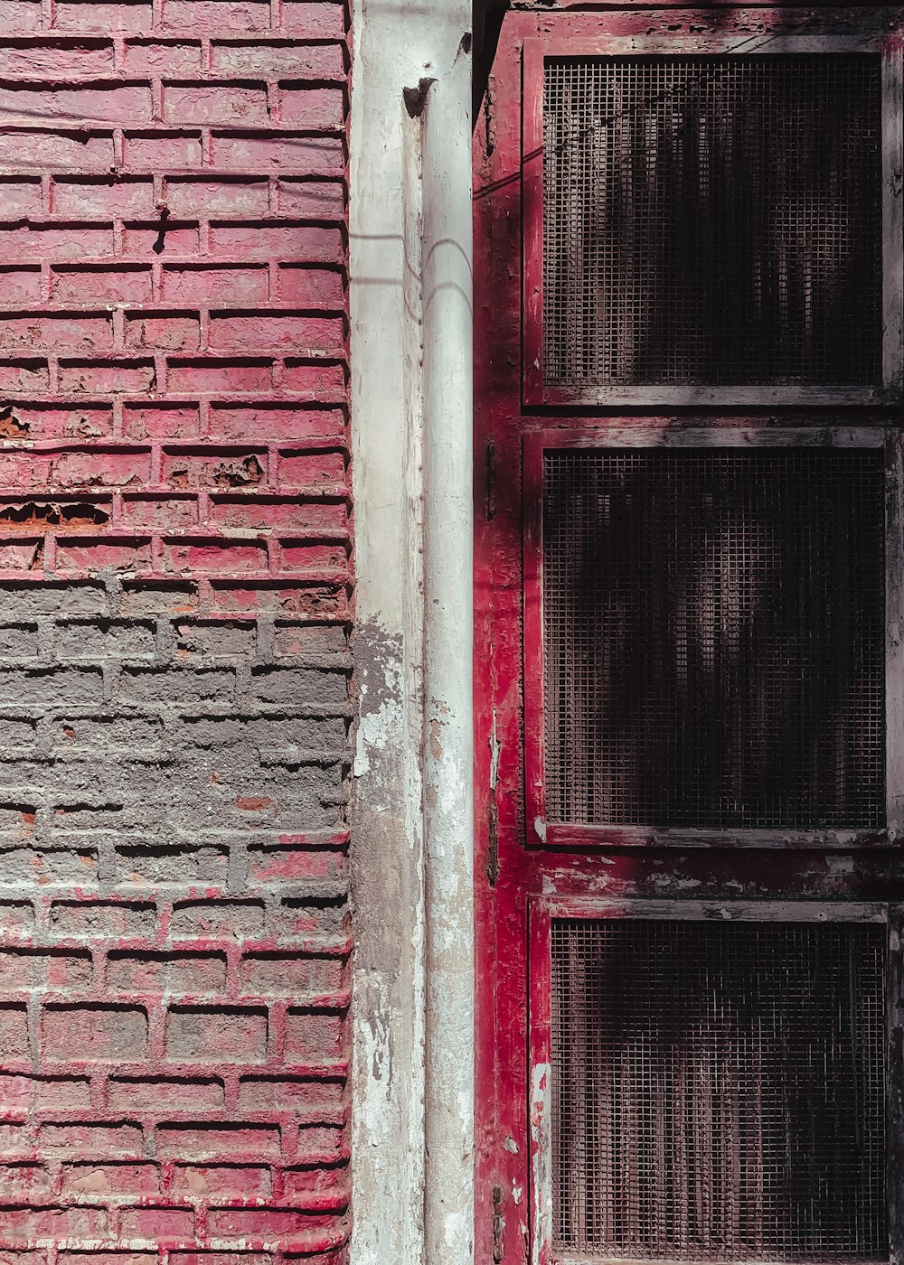a red brick wall with a window on it