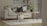 A cozy living room featuring a modern sofa with decorative cushions and a coffee table.