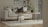 A cozy living room featuring a modern sofa with decorative cushions and a coffee table.