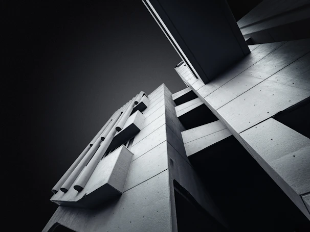 Close-up of a sleek concrete building facade with sharp geometric shapes.