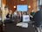 Close-up of a business meeting with charts and digital devices on the table.