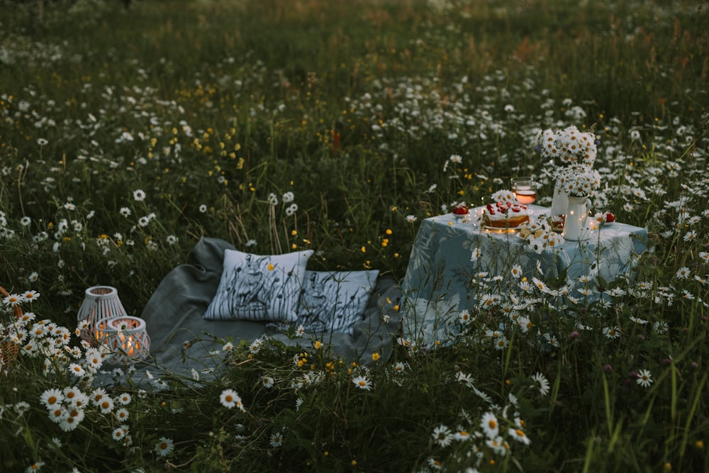 a picnic in the middle of a field of wildflowers