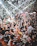 A crowd dancing under colorful lights at Yumbo Centrum with glitter and confetti in the air.