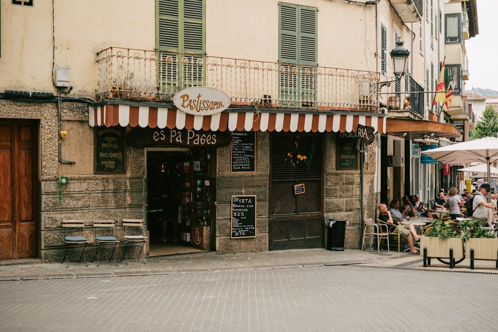 a group of people sitting outside of a restaurant