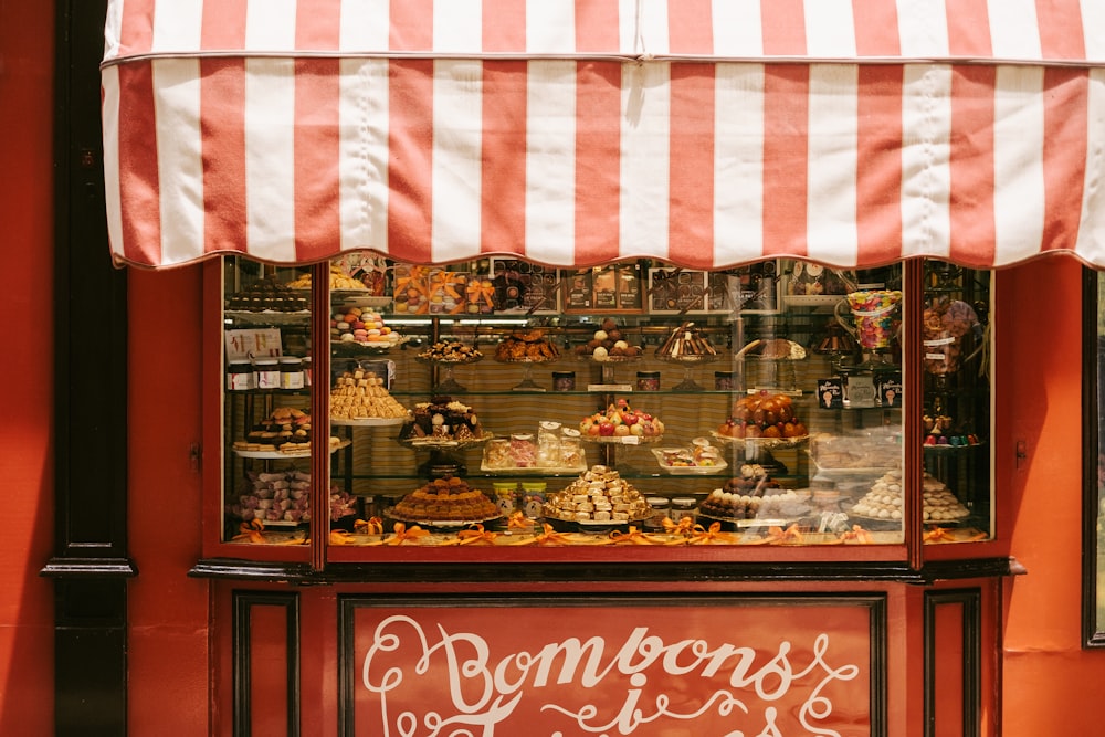 a store front with a red and white awning