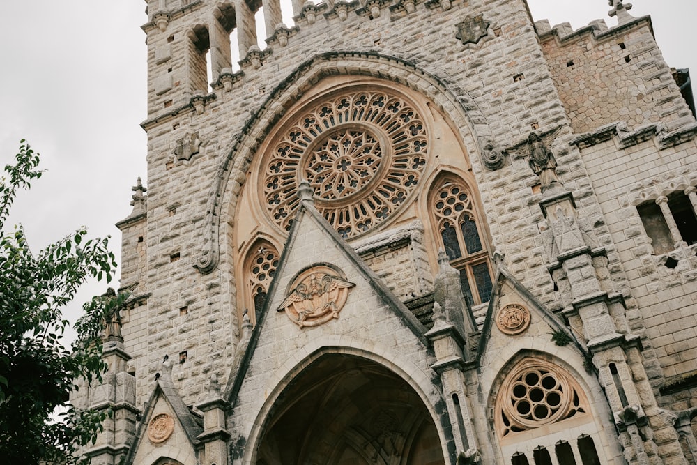 a large stone building with a clock on it's side