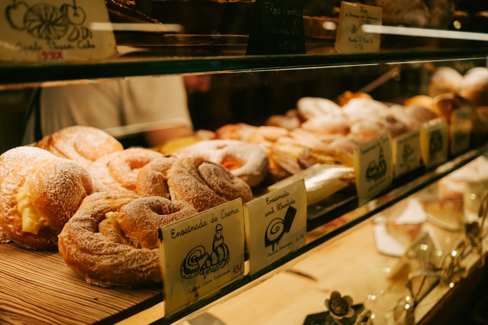 a display case filled with lots of different types of doughnuts