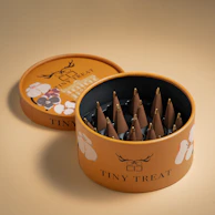 An artistic hat box filled with a blend of artificial flowers and gourmet treats.