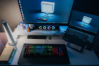 a computer desk with a laptop and a monitor