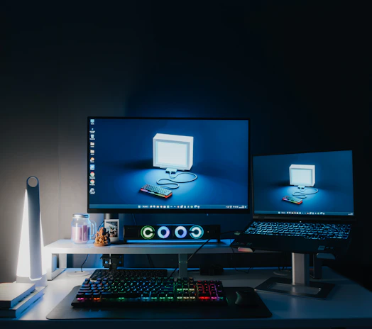 A workstation featuring dual monitors and ergonomic keyboard in a bright office.