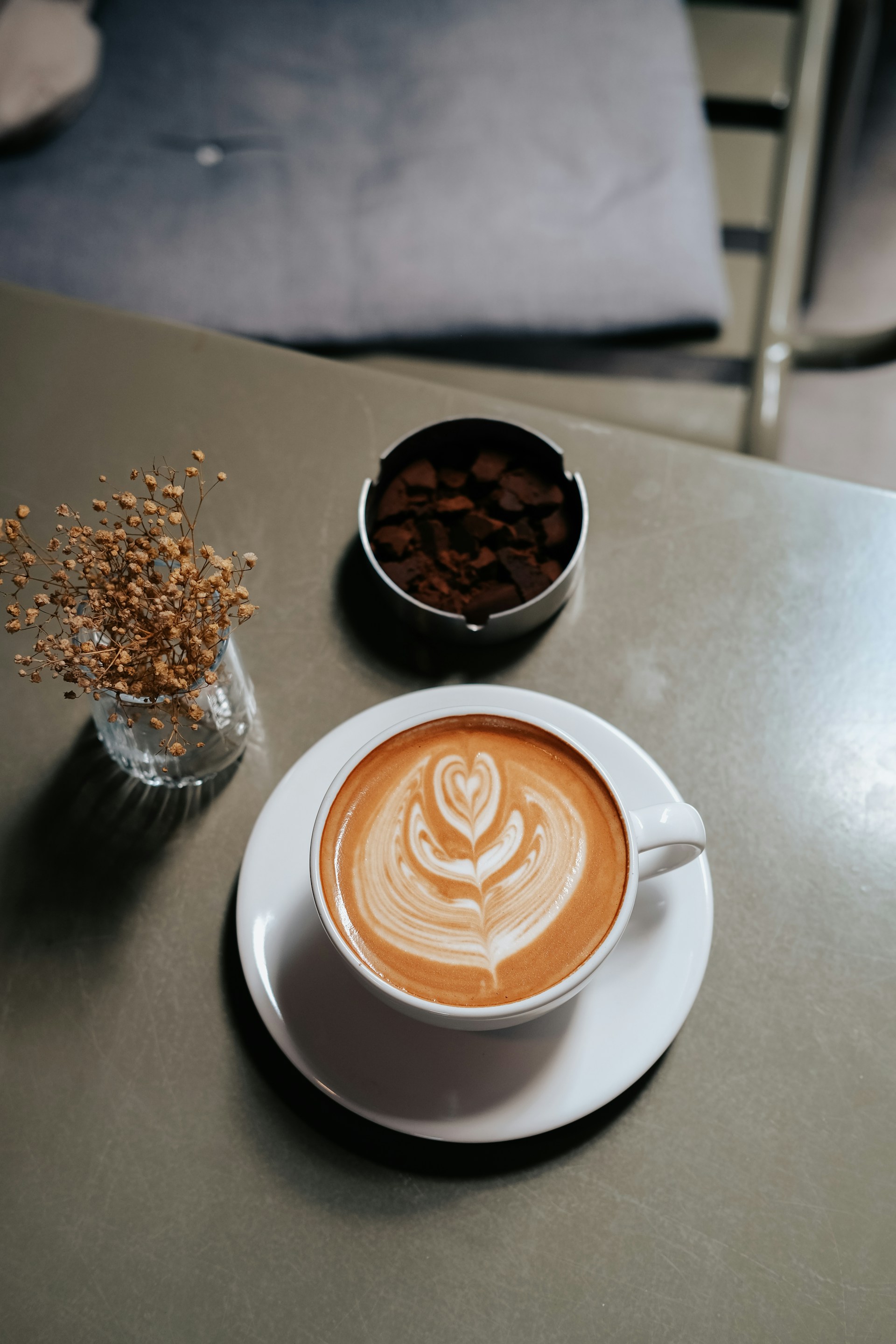 A beautifully arranged coffee table with artisanal pastries and a steaming cup of coffee.
