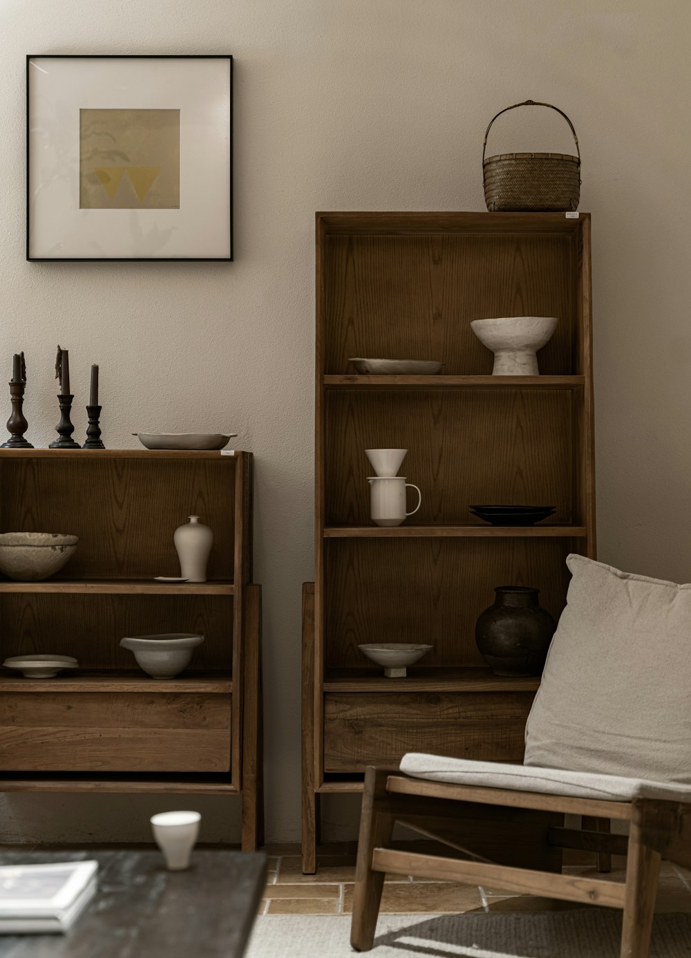 a living room filled with furniture and a painting on the wall