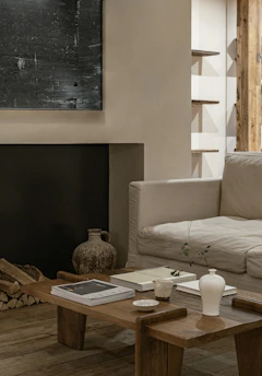 A cozy living room featuring a custom-made wooden sofa and matching coffee table