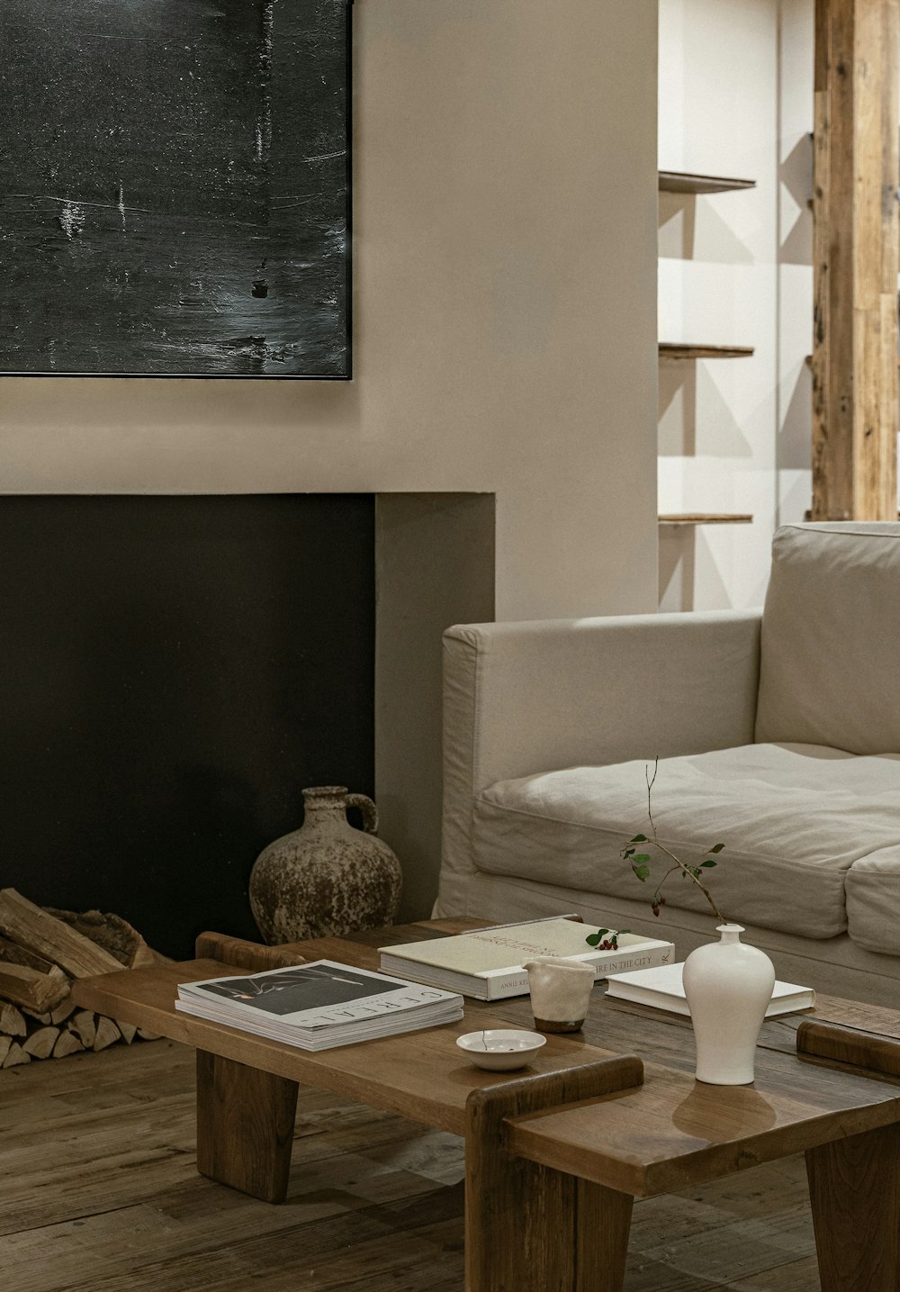 a living room with a white couch and a fireplace