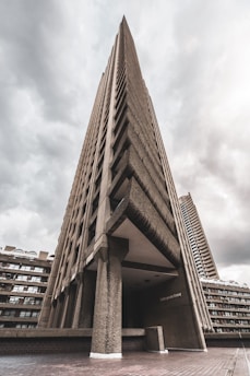 A striking brutalist concrete structure with sharp angles under moody skies.