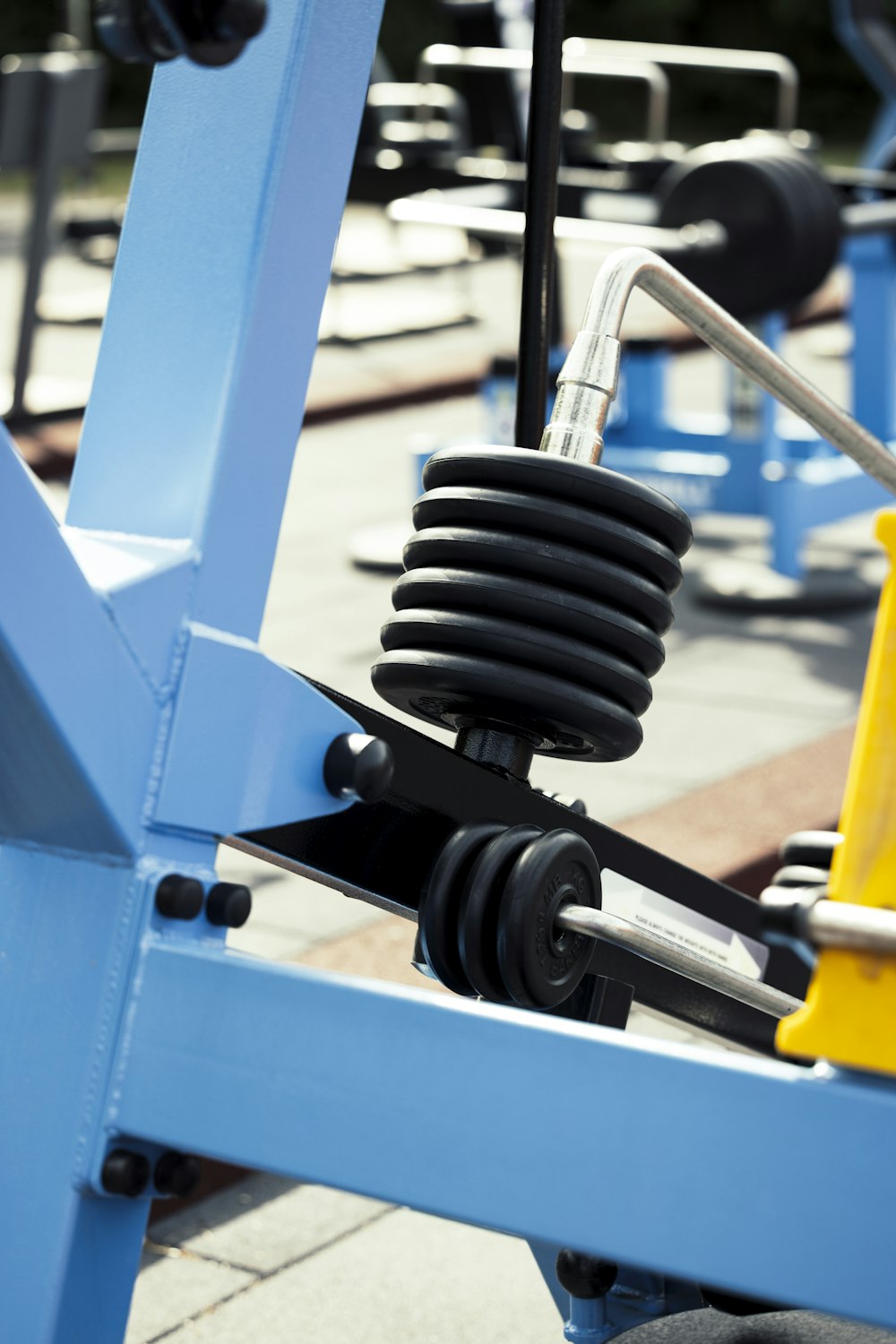 a blue bench with a pair of black dumbbells