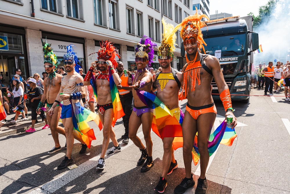 a group of men in colorful costumes walking down a street