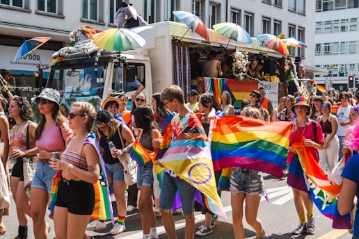 A vibrant street scene in Lima during a colorful LGBTQ+ pride parade.