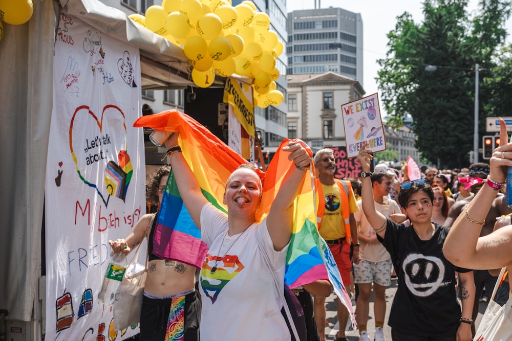 a group of people holding up signs and balloons