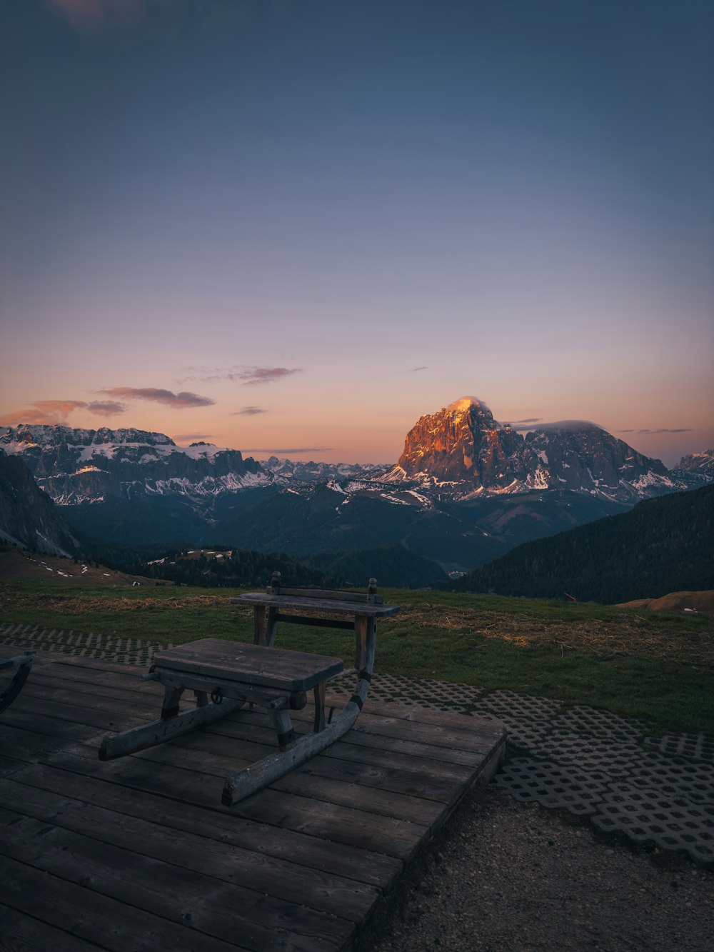 a picnic table sitting on top of a wooden platform