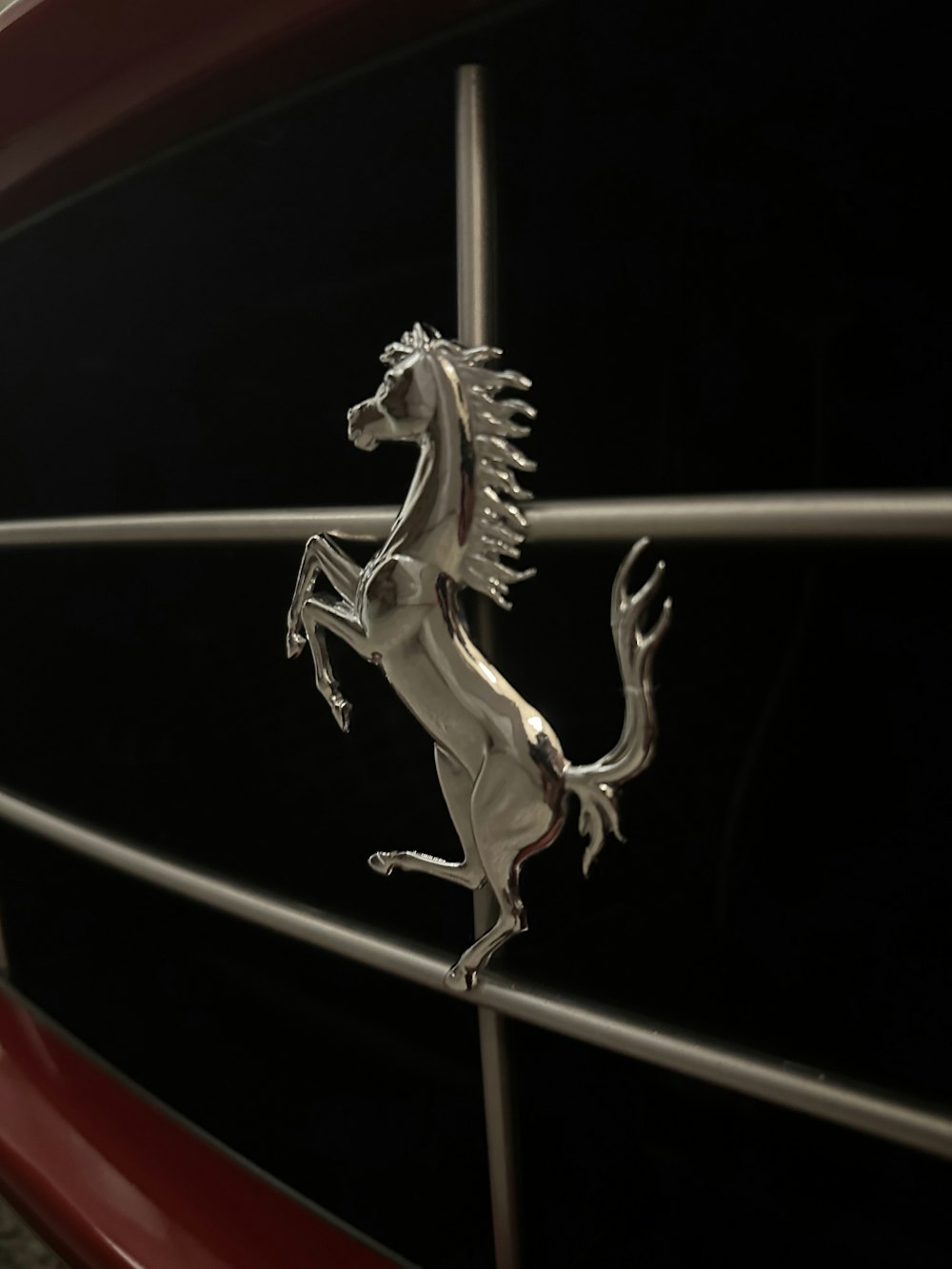 a close up of a horse on the front of a car
