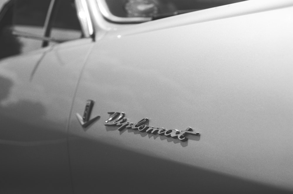 a black and white photo of a classic car