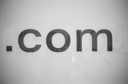 a black and white photo of the word comm
