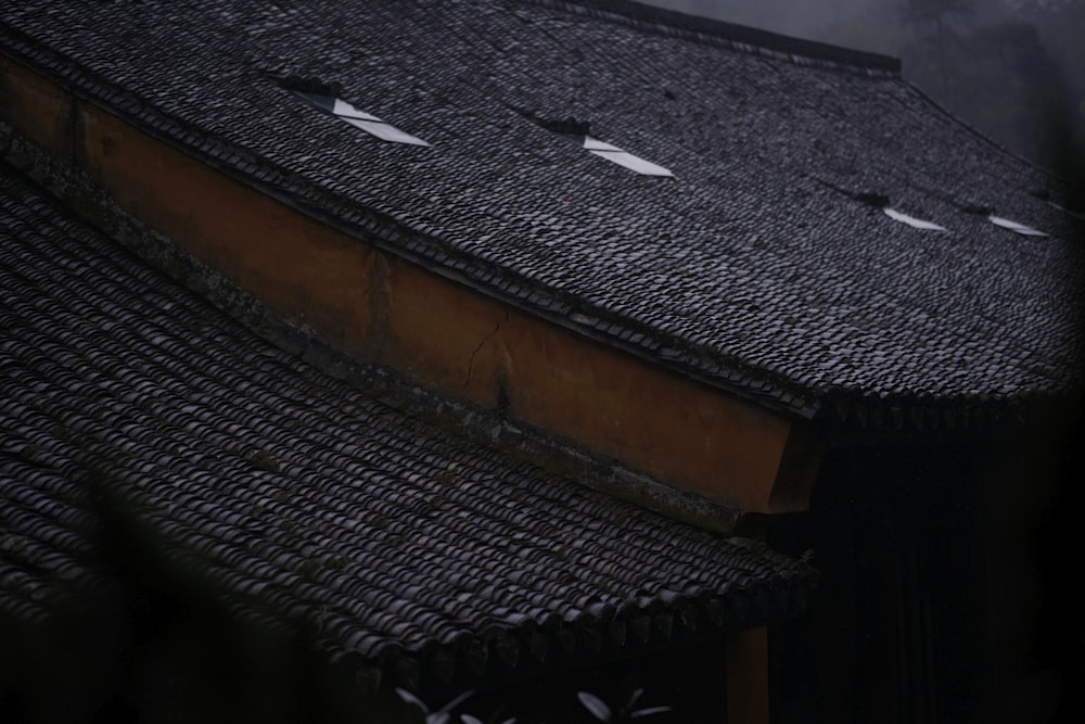 the roof of a building with three white birds on it