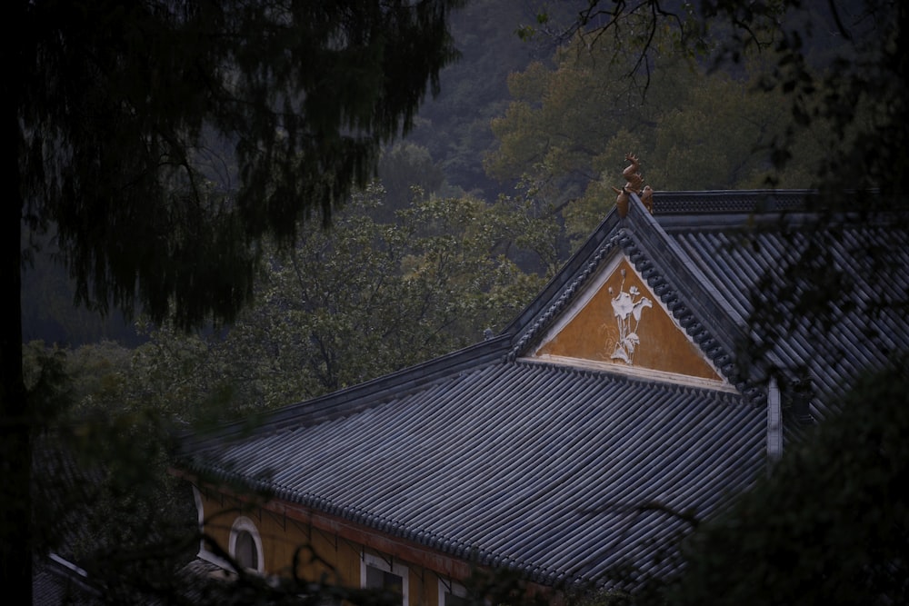 the roof of a building with a tree in the background