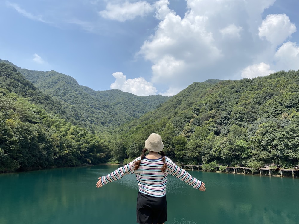 a person standing on a boat in a lake