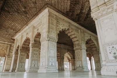 Close-up detail of the hall’s intricate stonework framed by lush gardens